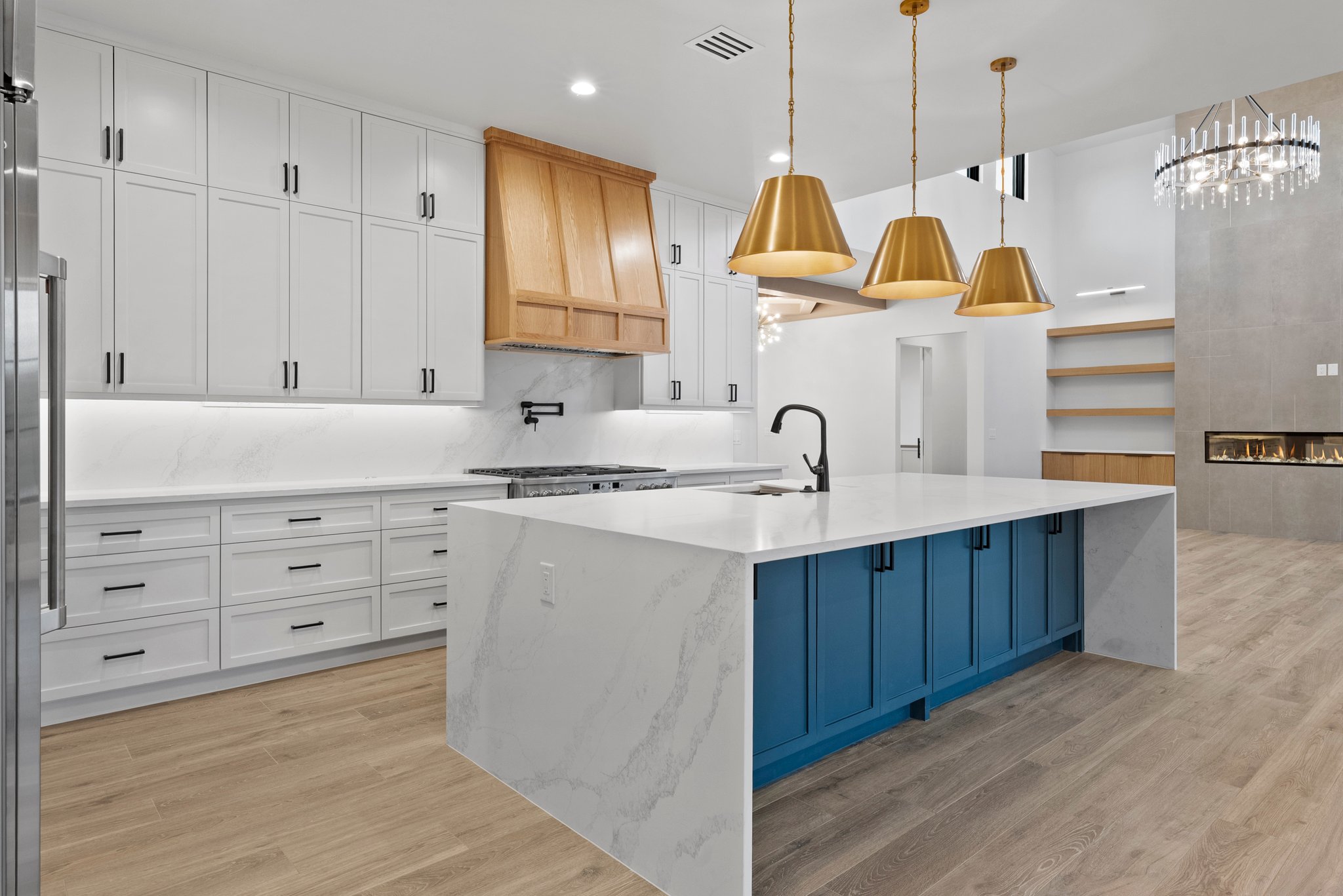 Ember House kitchen with a deep blue island and warm wood accents