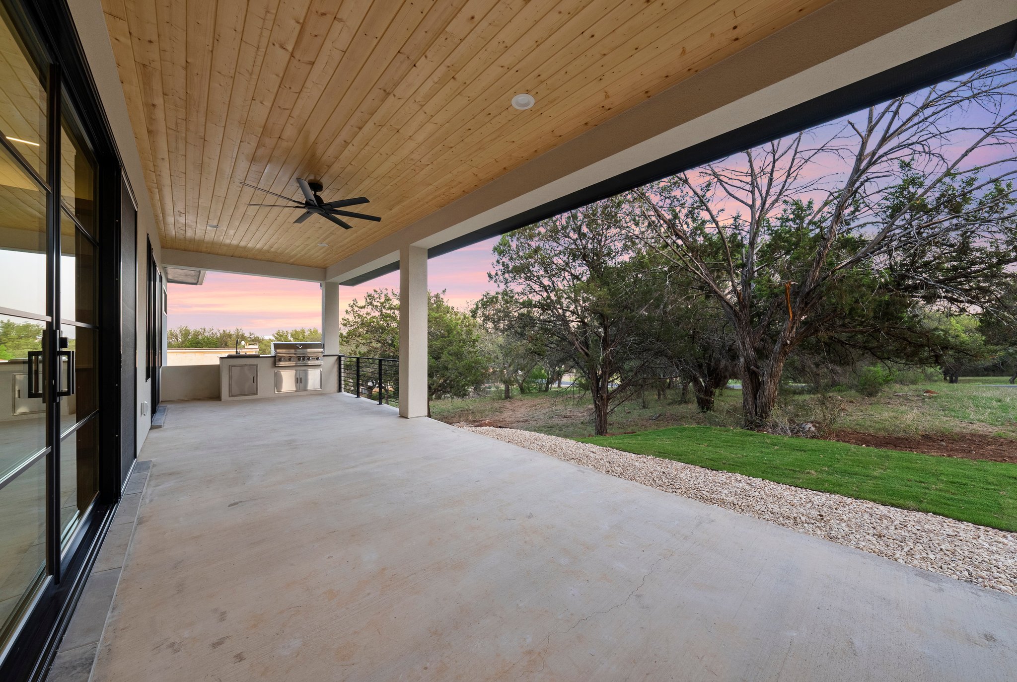 Ember House covered terrace opening to mature trees