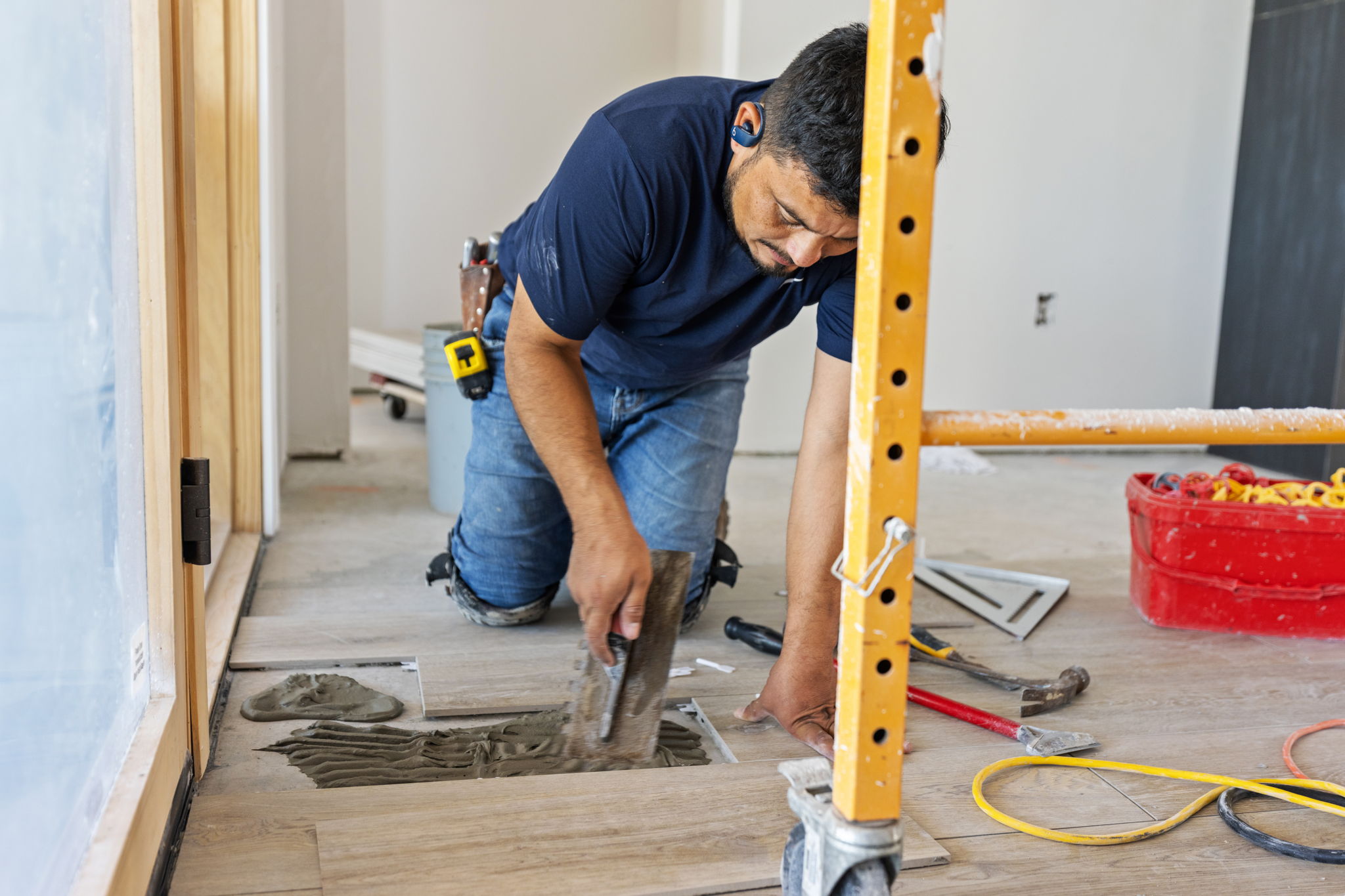 A craftsperson setting tile at The Lookout